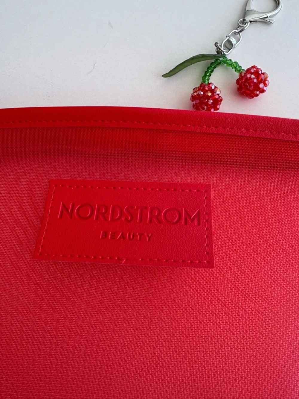Nordstrom Beauty Bright Red Mesh Cosmetic Pouch with Wrist Strap and Cherry Char